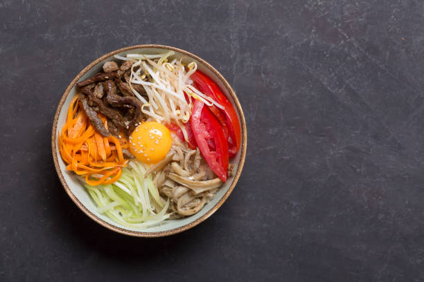 istock Traditional Asian Bibimbap dish with rice and vegetables on dark background 1068278904