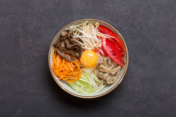 istock Traditional Asian Bibimbap dish with rice and vegetables on dark background. Central composition 1068278940