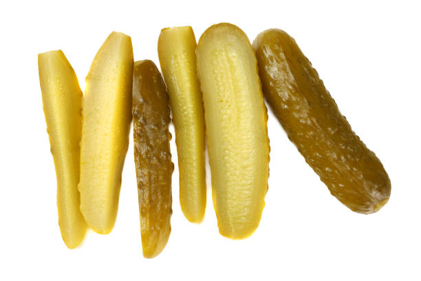 istock sliced marinated pickled cucumbers isolated on white background. top view 1068279070