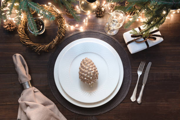 istock Christmas table setting with silverware, garland and dark decor. Top view. Xmas Party. Magic night. 1068282312