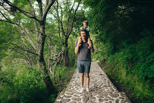 Father carrying son on his shoulders