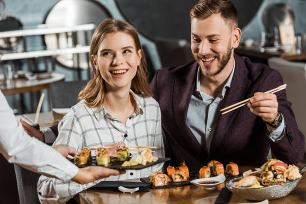istock Attractive smiling couple having dinner in restaurant 1068293264