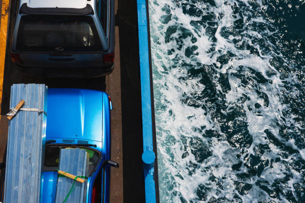 istock Trucks on car ferry moving on sea with white waves 1068295160