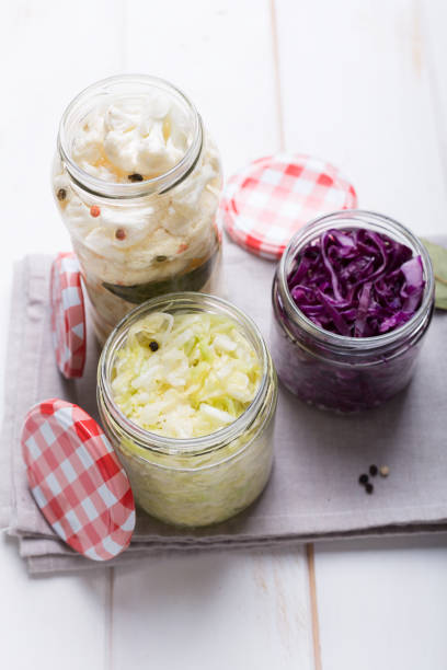 istock Sauerkraut in jars on a wooden table. Top view 1068303490
