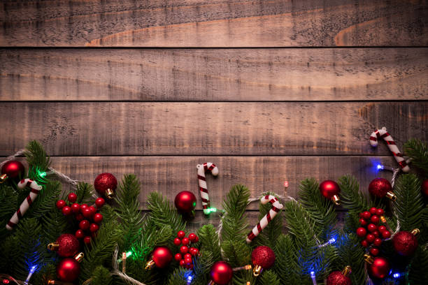istock Christmas background concept. Top view of Christmas gift box red sock with spruce branches, pine cones, red berries and bell on old wooden background. 1068303664