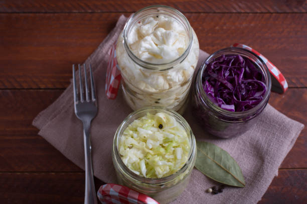 istock Sauerkraut in a blue bowl on a wooden table. Top view 1068303678