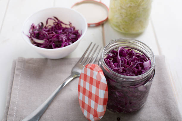 istock Homemade fermented cabbage in jars on a wooden table 1068303682