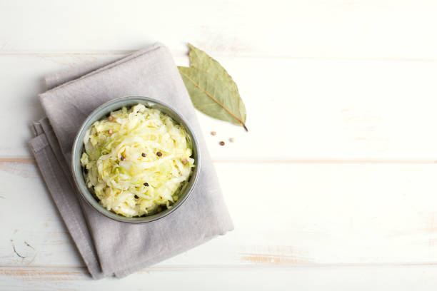 Sauerkraut in a blue bowl on a wooden table