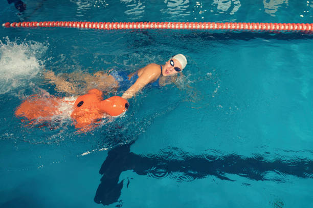 istock Water Rescue Training Trainer and Training Dummy in a Pool 1068313282