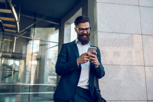 istock Young businessman typing text message on mobile phone outdoors 1068313436