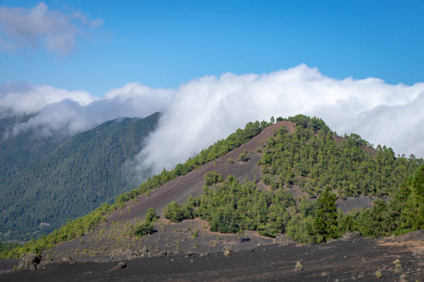istock Clouds rolling over the volcanic blast crater ridge at Llanos del Jable, La Palma, Canary Islands, Spain 1068322184
