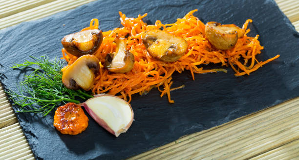 istock Slate of freshly fried mushrooms with carrot 1068322430