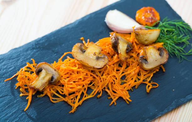 istock Slate of freshly fried mushrooms with carrot 1068322466