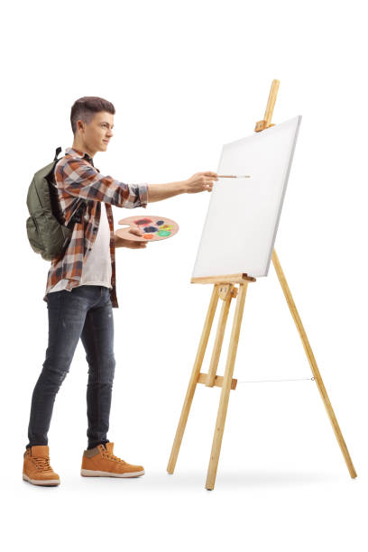 istock Teenage boy painting on a canvas 1068325026