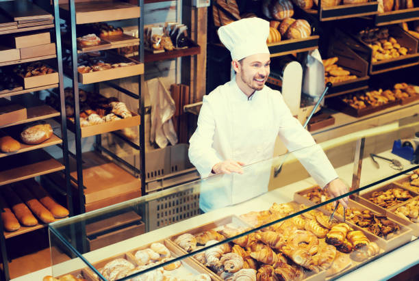 istock Good baker showing assortment of bakery 1068332082