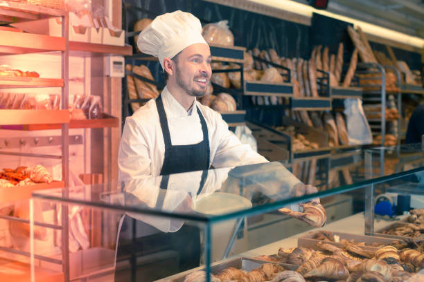 istock Good male pastry maker demonstrating croissant 1068332126