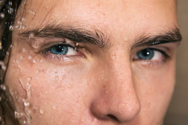 istock Sexy guy washes in the shower. 1068332828