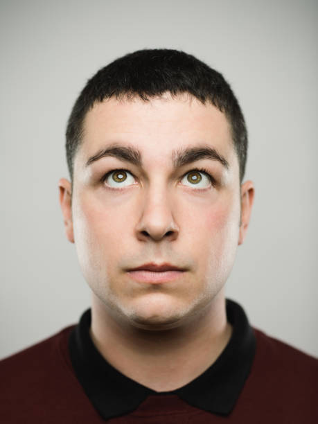 istock Portrait of a real young caucassian man looking up. 1068333338