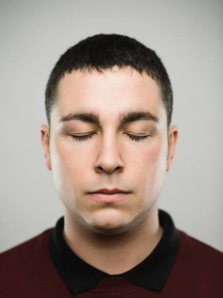 istock Portrait of a young caucassian man closing his eyes 1068333472