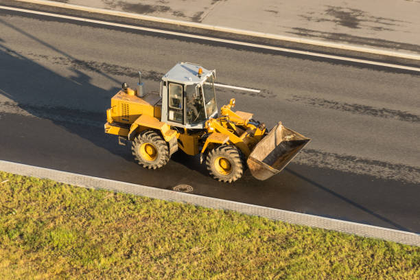 istock Yellow tractor with a bucket on the highway. 1068344202