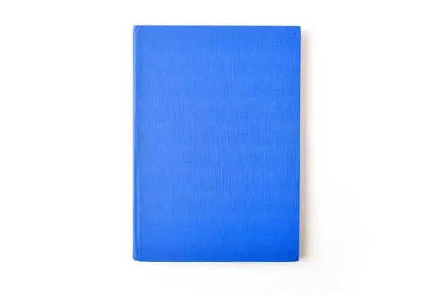 one blue book on light background with copy space