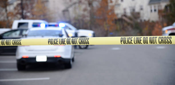 istock Police tape blocking access to a crime scene. 1068350038