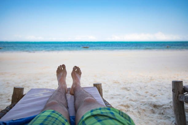 Young Adult Man Relaxing on Beach.