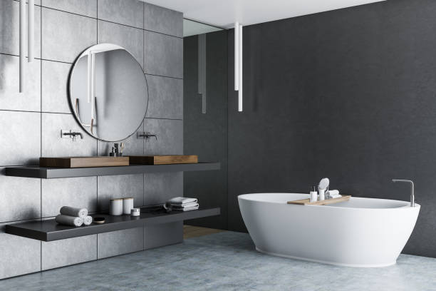 istock Gray tile bathroom corner, double sink and tub 1068359040