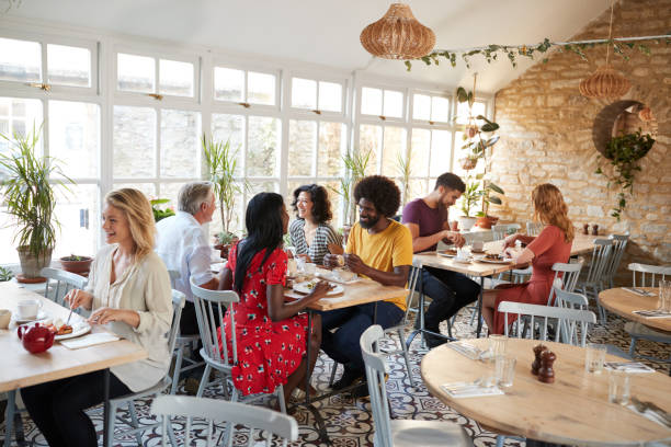 istock Customers eating at a busy restaurant in the day time 1068362092