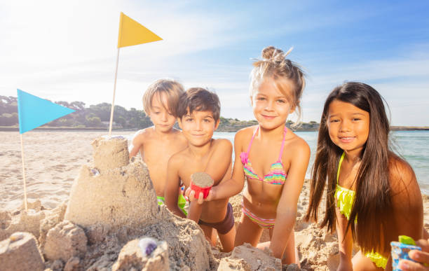 istock Funny kids building sandcastle using sandpit toys 1068362906