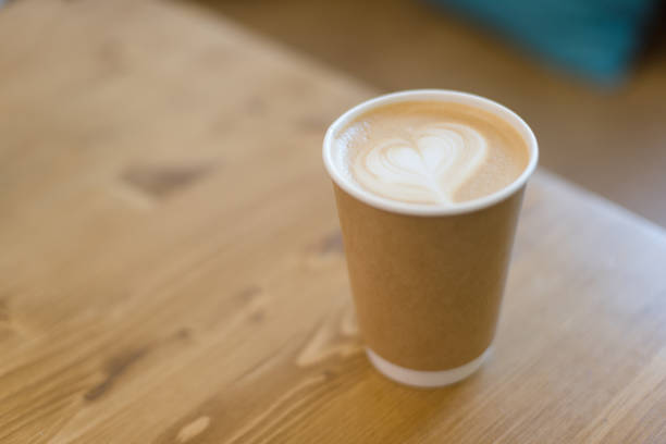 istock Cup of a latte on a wooden table. 1068364950