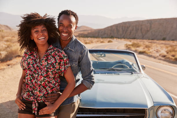 istock Young black couple on road trip having a roadside stop off 1068365218