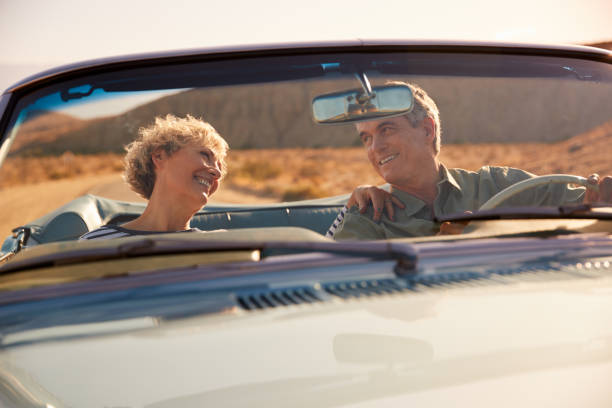 istock Senior couple on a US road trip, seen through car windscreen 1068365294