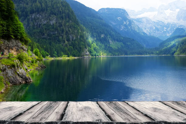 istock Wooden empty table and mountains landscape background 1068365836