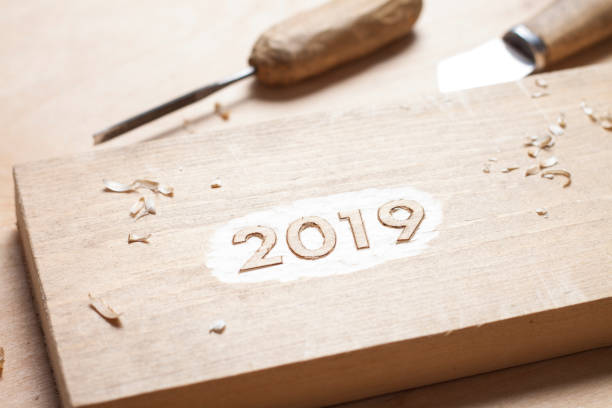 Carved wooden digits 2019 of the New Year on old rustic wooden table stock photo