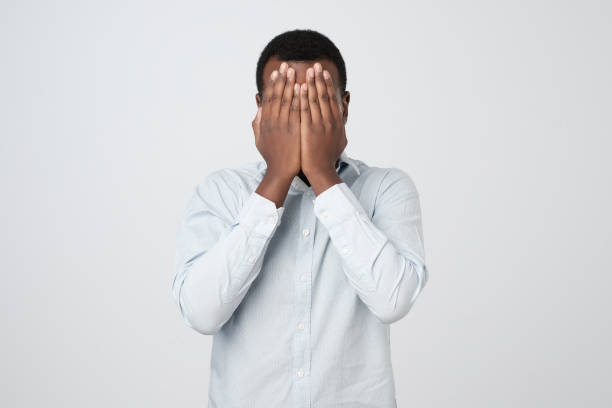 istock Young african man covered his face with hand 1068369602