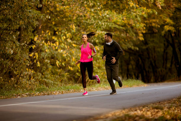 istock Young people jogging and exercising in nature 1068369656
