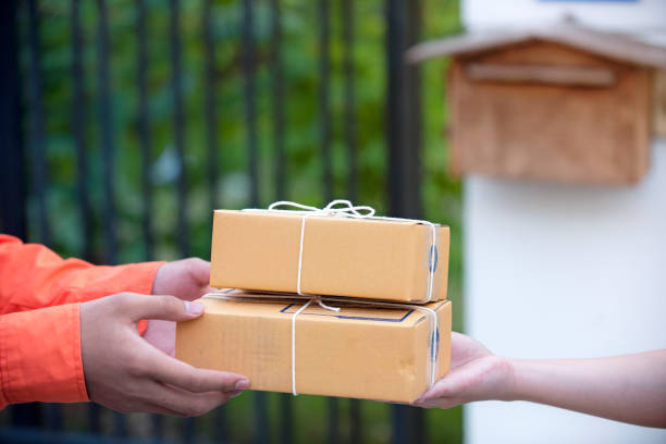 istock Woman hand accepting a delivery brown boxes 1068370682