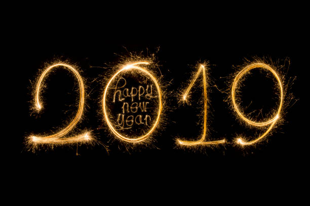 istock Happy new year 2019 text written with Sparkle fireworks isolated on black background 1068370956