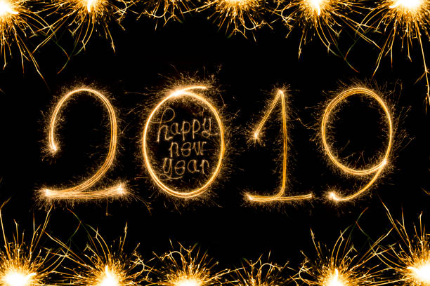 istock Happy new year 2019 text written with Sparkle fireworks isolated on black background 1068371024