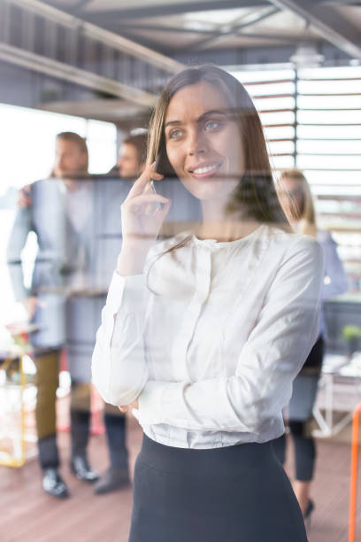 istock Beautiful businesswoman using a cell phone in her office 1068373846