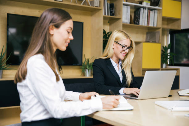 istock Two young women working in the office 1068373858