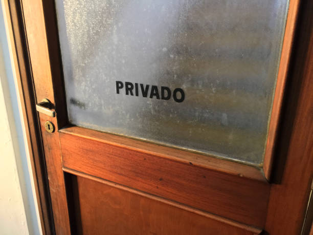 private Buenos Aires, Argentina - November 14, 2018: Close-up view of wooden door with the word 'privado' written on it to restrict access in business offices building frosted glass door office stock pictures, royalty-free photos & images