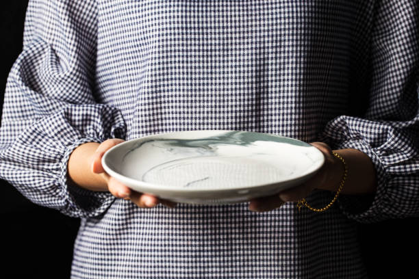 istock Women hold white plates in their hands. 1068374480