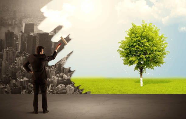 istock Salesman painting tree instead of city 1068374484