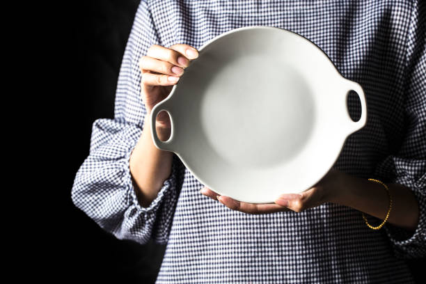 istock Women hold white plates in their hands. 1068374504