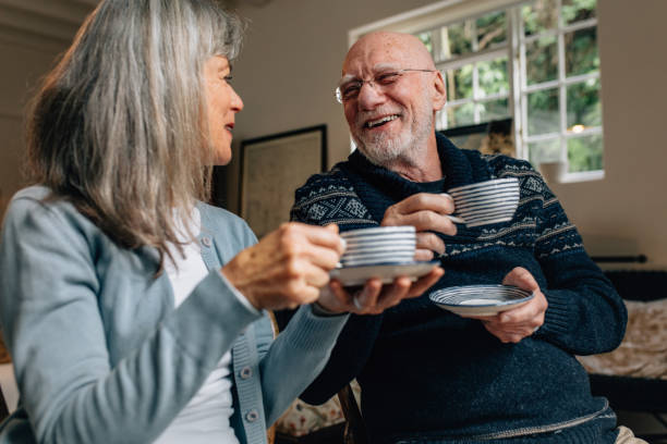 istock Senior couple enjoying coffee at home 1068378448