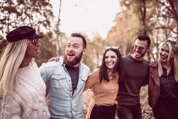 istock Group Of Happy Young People Singing In The Park 1068378532