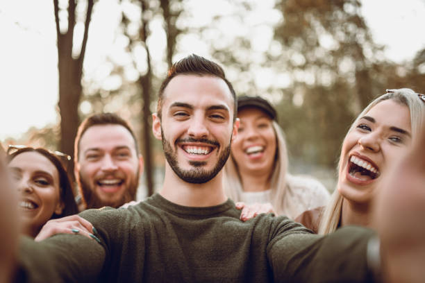 istock Cheerful Group Selfie In An Autumn Ambient 1068378670