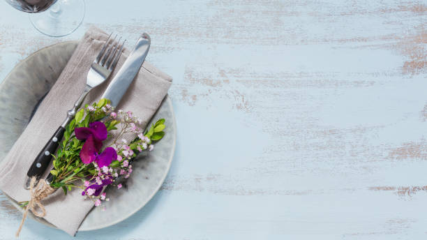 istock Rustic table setting with purple flowers on light wooden table. 1068378736